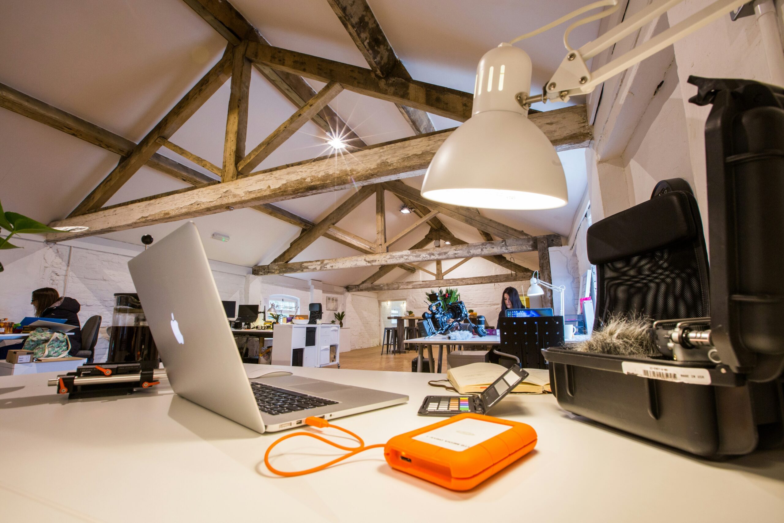 Illustration showing an overwhelmed consultant surrounded by paperwork and laptops